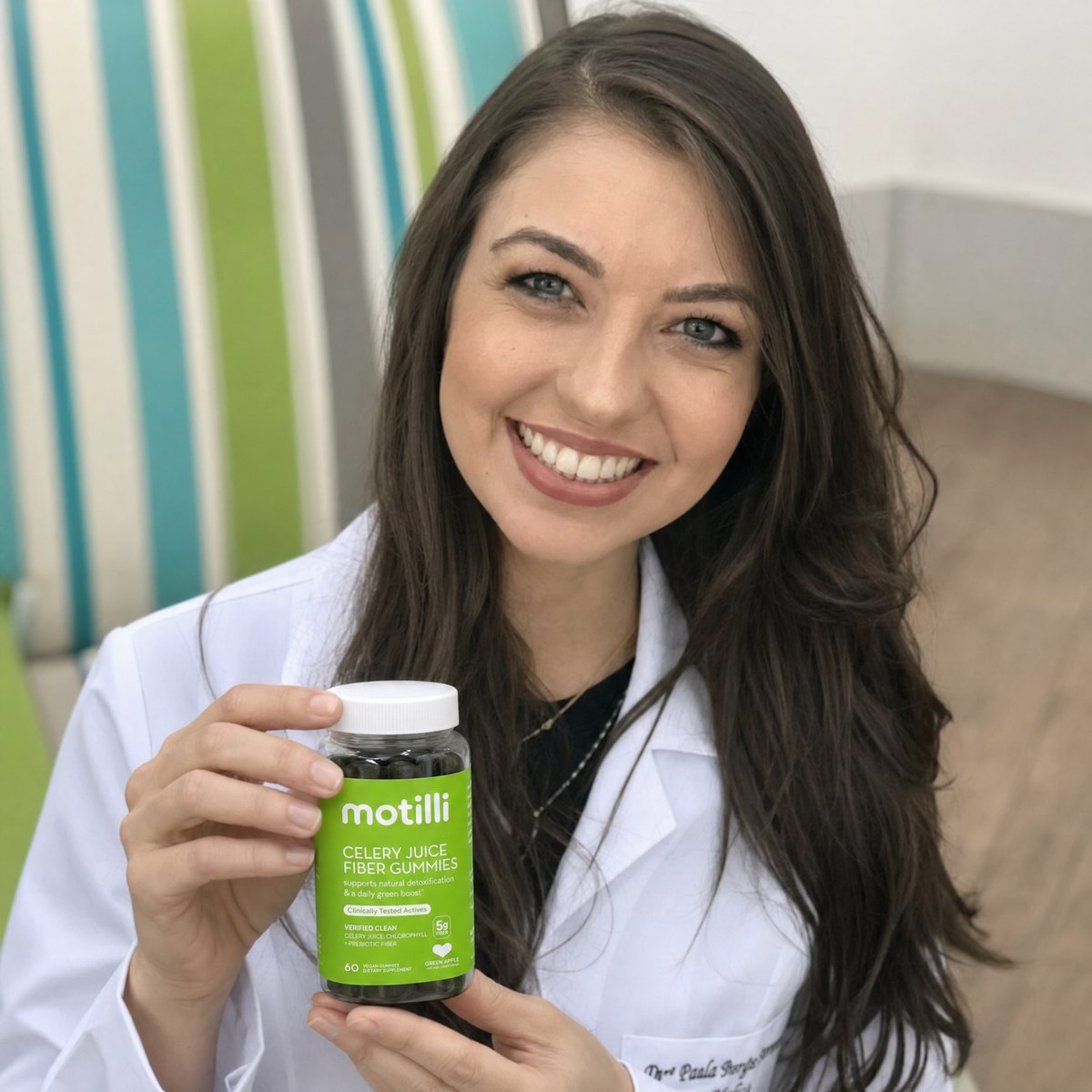 Gastroenterologist holding Motilli bottle — clinical authority figure